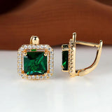 Golden earrings with green square zircons
