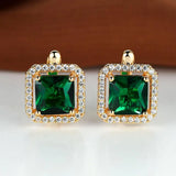 Golden earrings with green square zircons