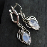 Silver earrings with a white crystal