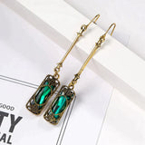 Golden earring with green pendant