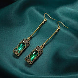 Golden earring with green pendant
