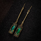 Golden earring with green pendant