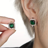 Golden earrings with green square zircons
