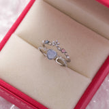 Adjustable silver ring with a blue stone and zirconia