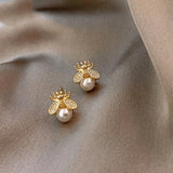 Diamond and pearl earrings with a gold finish