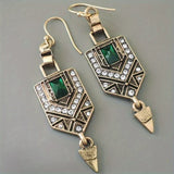Golden earring with green zircon
