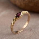 Golden vintage ring with a red crystal