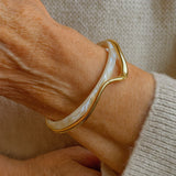 Elegantly opened bangle with white and gold enamel