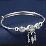 Adjustable bracelet with three leaf-shaped silver pendants