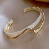Elegantly opened bangle with white and gold enamel