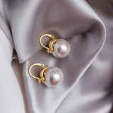 Thick pearl earrings in gold colour