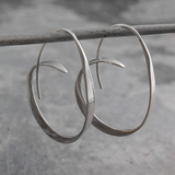 Ring of large spiral earrings