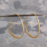 Ring of large spiral earrings