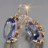 Old-fashioned earrings with blue zircon