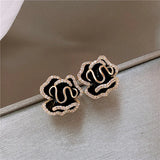 Elegant black lotus earrings with a golden finish