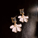 Pearl earrings with a white flower
