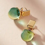 Vintage earrings with green crystal in a golden hue