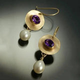 Golden earring with purple details and pearls