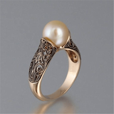A golden vintage ring with a pearl
