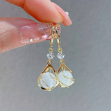 Golden pendant earring with white opal