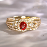 Layered golden ring with a red glitter distribution