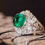 Vintage floral ring with a green stone and diamonds