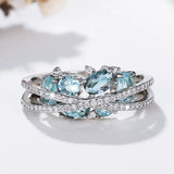 Silver ring with a cross and a blue gemstone