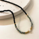 Black beaded necklace with gold and pearls